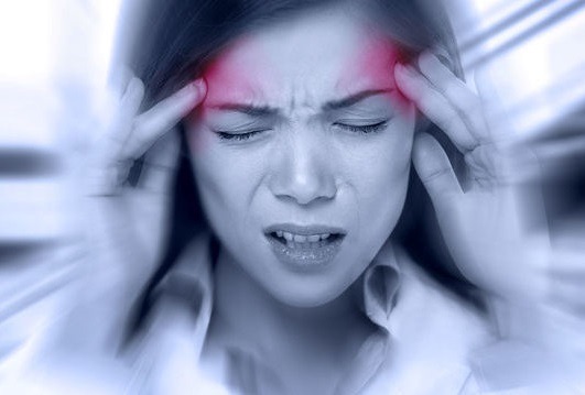 Woman holding her head with marks illustrating migraine pain.